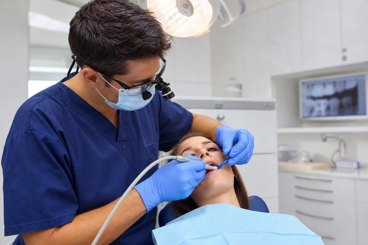 Dentist carefully performing root canal treatment at Sunrays Smiles Dental Care in Winter Springs, FL